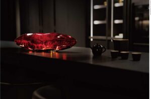 Red crystal sculptural table lamp on a dark counter - Lytronex decorative lighting